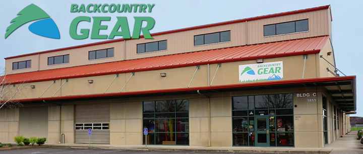 Outside view of the Backcountry Gear store, a tan building with red shingle rooftop